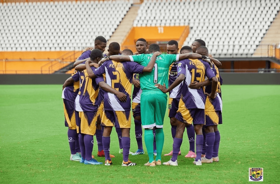 An image of a football team in a huddle